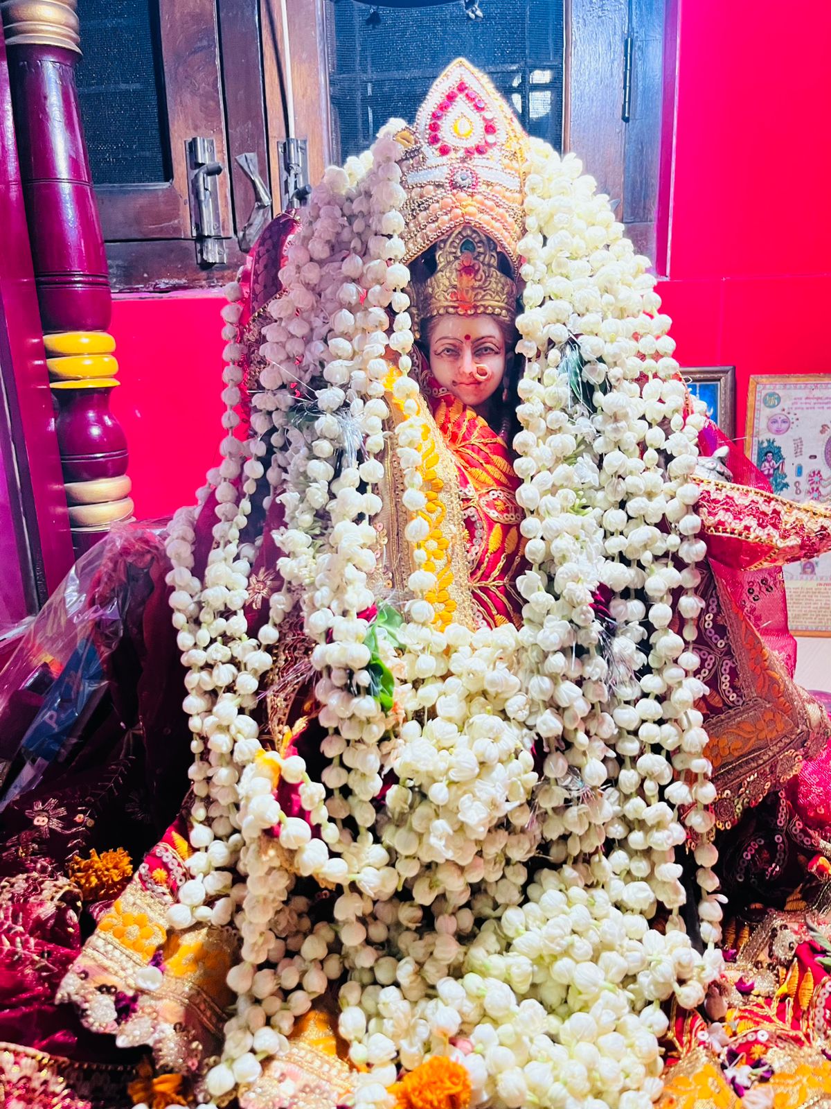 Devi adorned with flowers and a crown