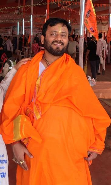 BabuaJi Shukla wearing saffron clothing